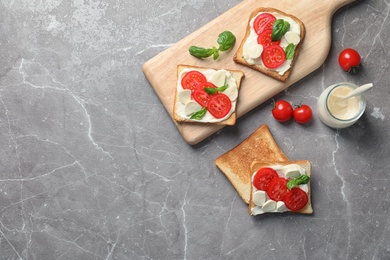 Photo of Flat lay composition with toast bread, cream cheese and cherry tomatoes on color background