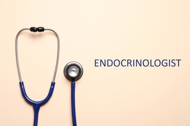 Endocrinologist. Stethoscope on beige background, top view