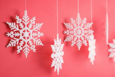 Beautiful decorative snowflake hanging on red background, closeup