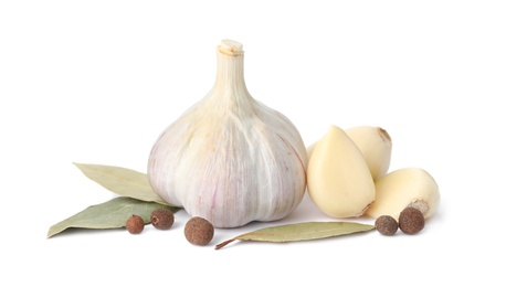 Photo of Fresh garlic bulb and cloves with seasonings isolated on white. Organic food