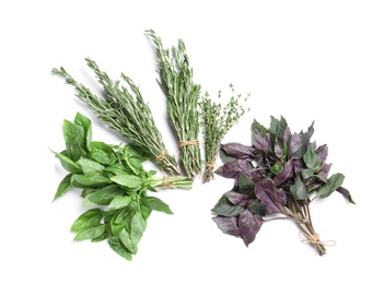 Rosemary and other aromatic herbs on white background, top view