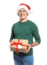 Photo of Young man with Christmas gift on white background