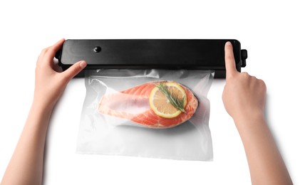 Photo of Woman using vacuum sealer on white background, top view. Salmon with lemon in pack