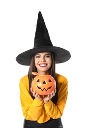 Photo of Beautiful woman wearing witch costume with Jack O'Lantern candy container for Halloween party on white background