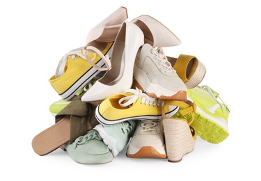 Photo of Pile of different female shoes isolated on white