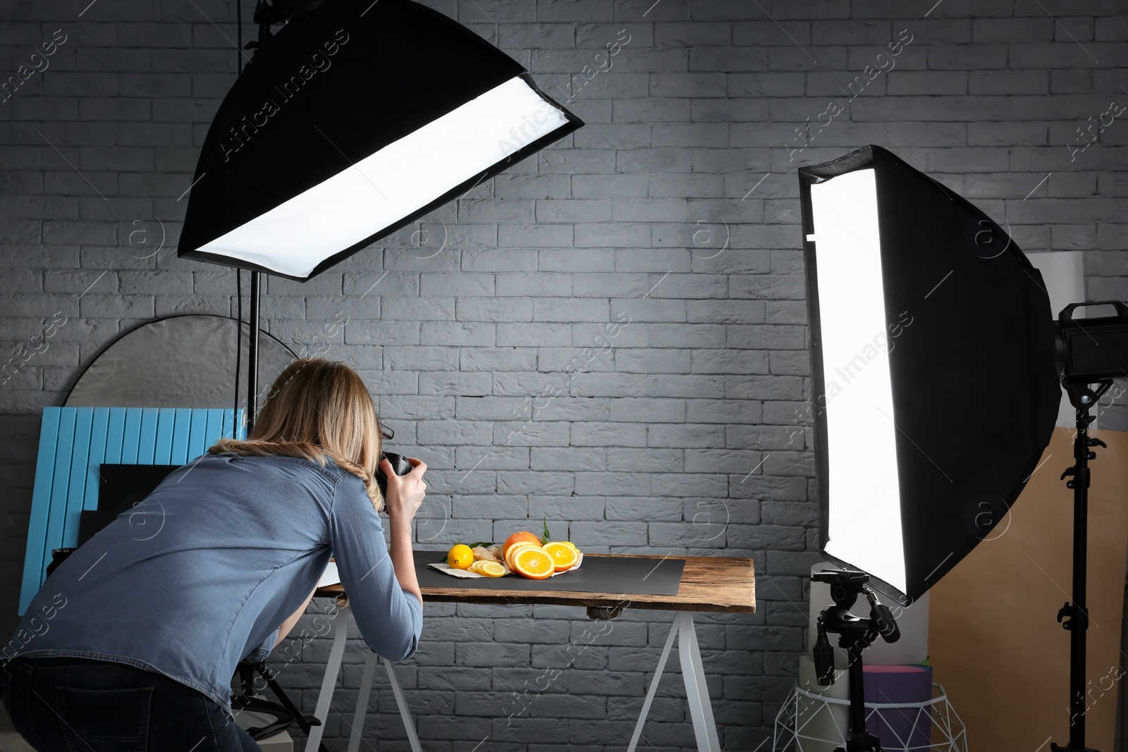 Photo of Woman taking photo of food with professional camera in studio