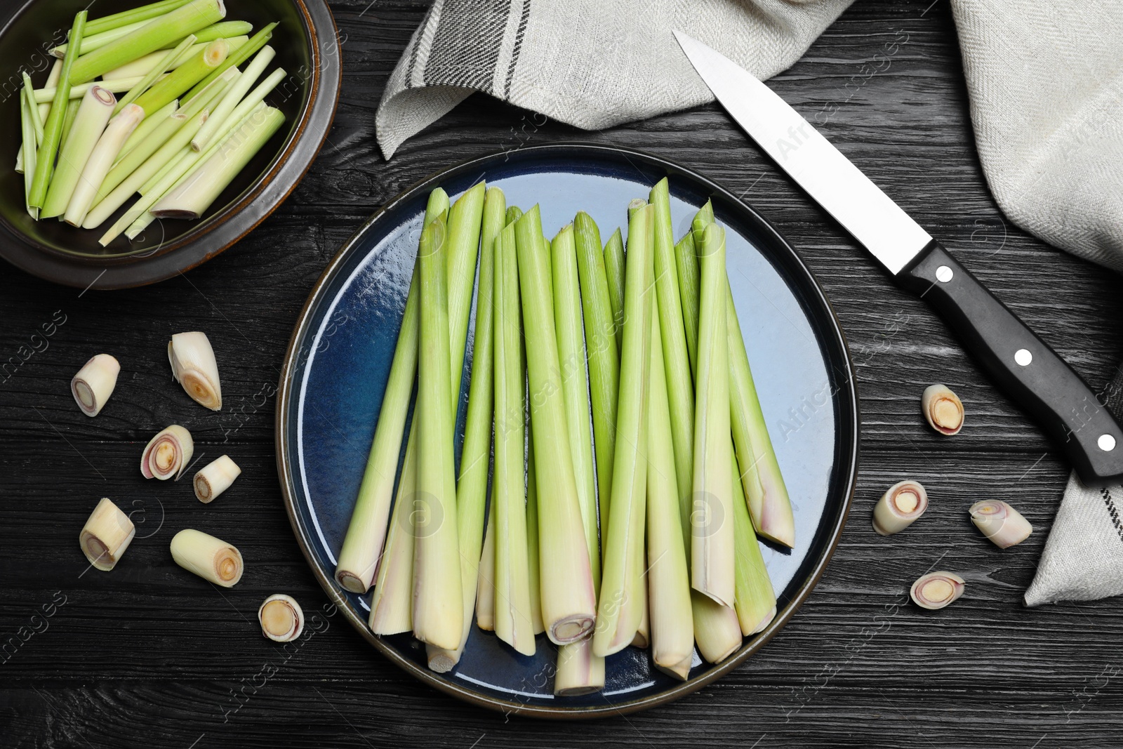 Photo of Flat lay composition with fresh lemongrass stalks on black wooden table