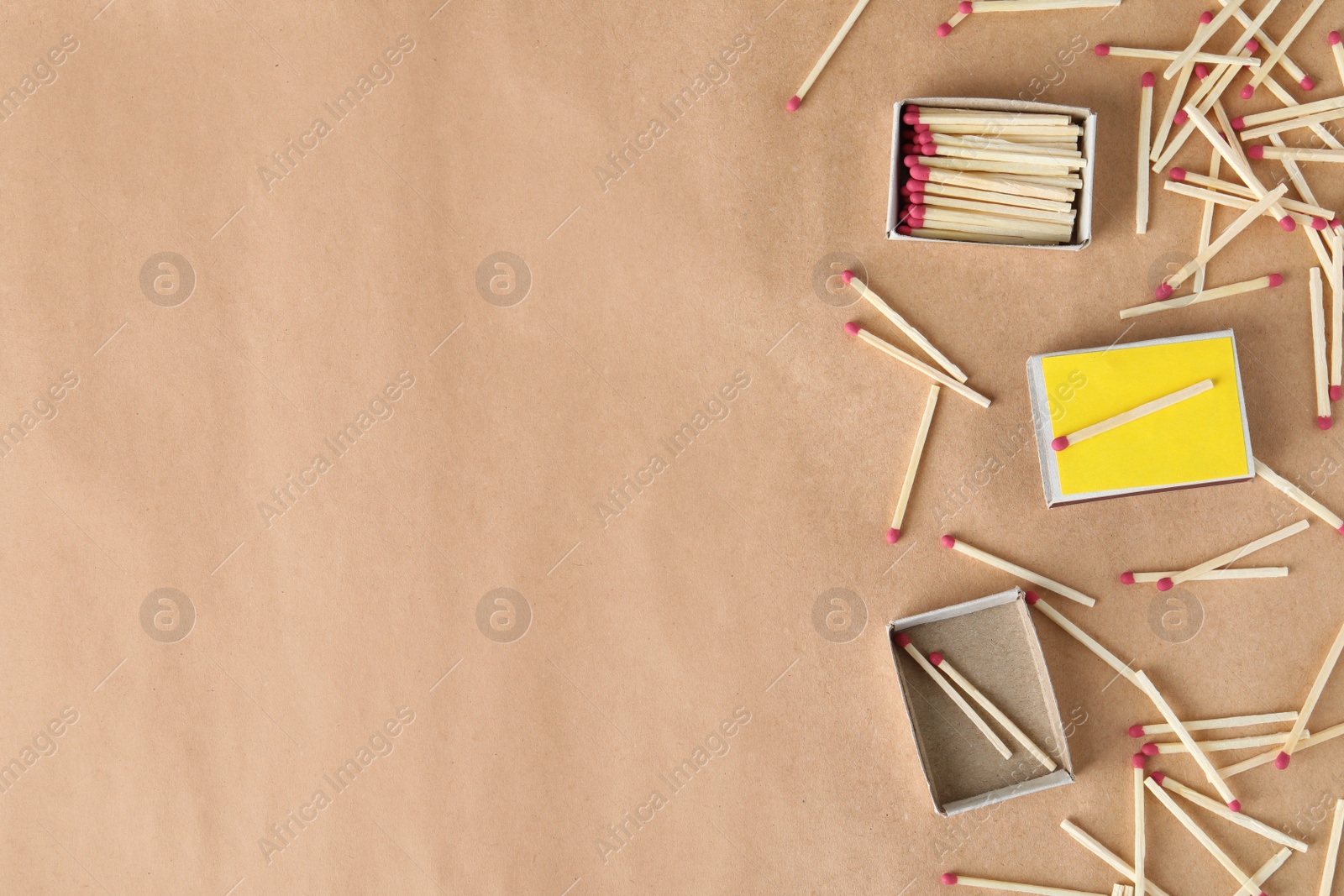 Photo of Flat lay composition with matches and space for text on craft paper