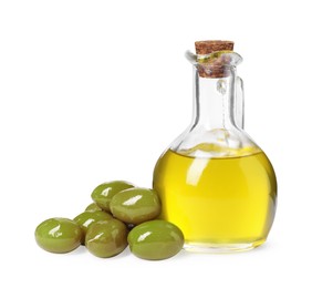 Photo of Glass jug of cooking oil and ripe olives isolated on white