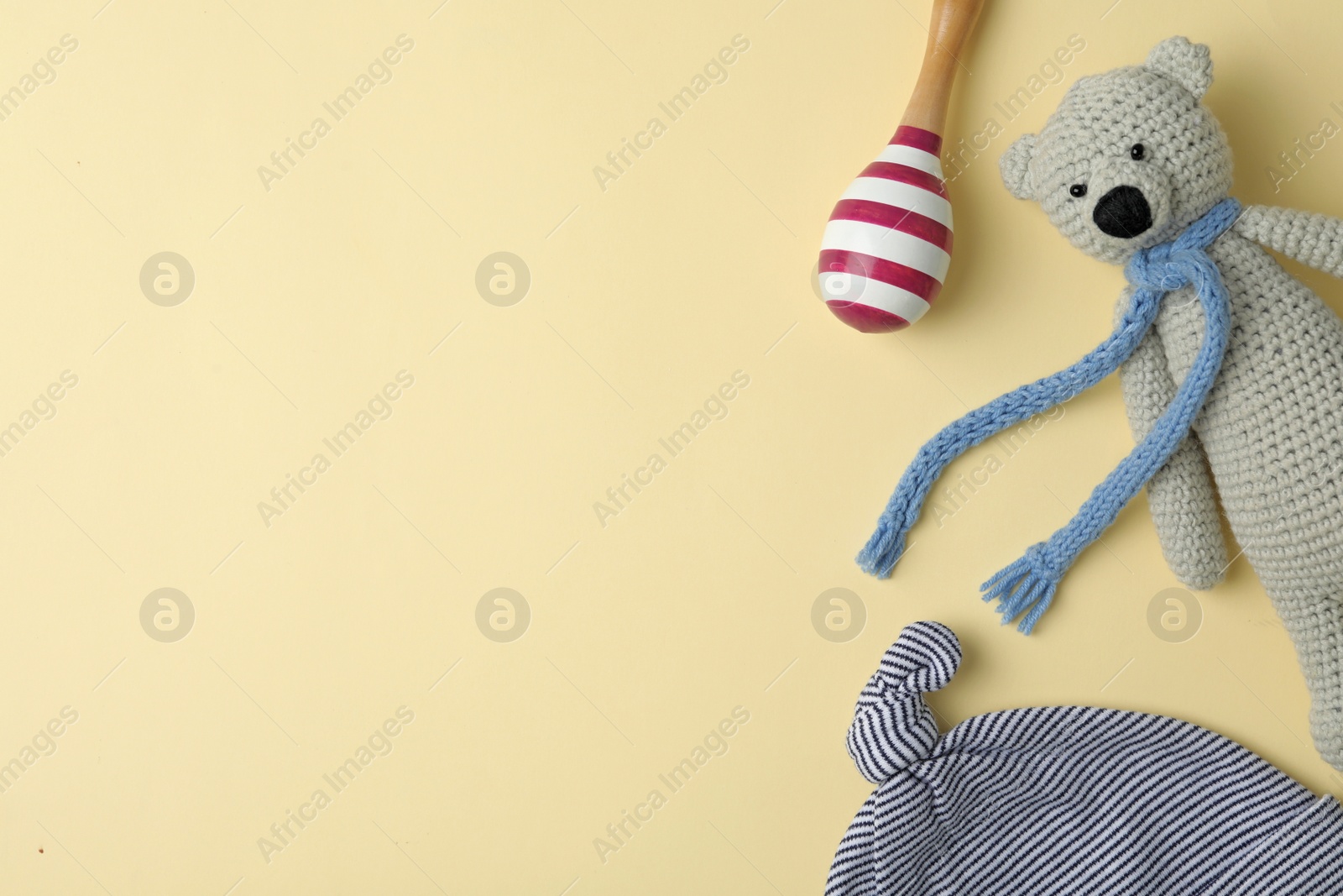 Photo of Child's cap and toys on beige background, flat lay with space for text