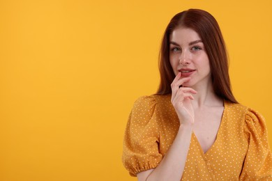 Photo of Portrait of beautiful woman with freckles on yellow background. Space for text