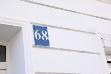 Photo of Plate with house number sixty eight on white building outdoors