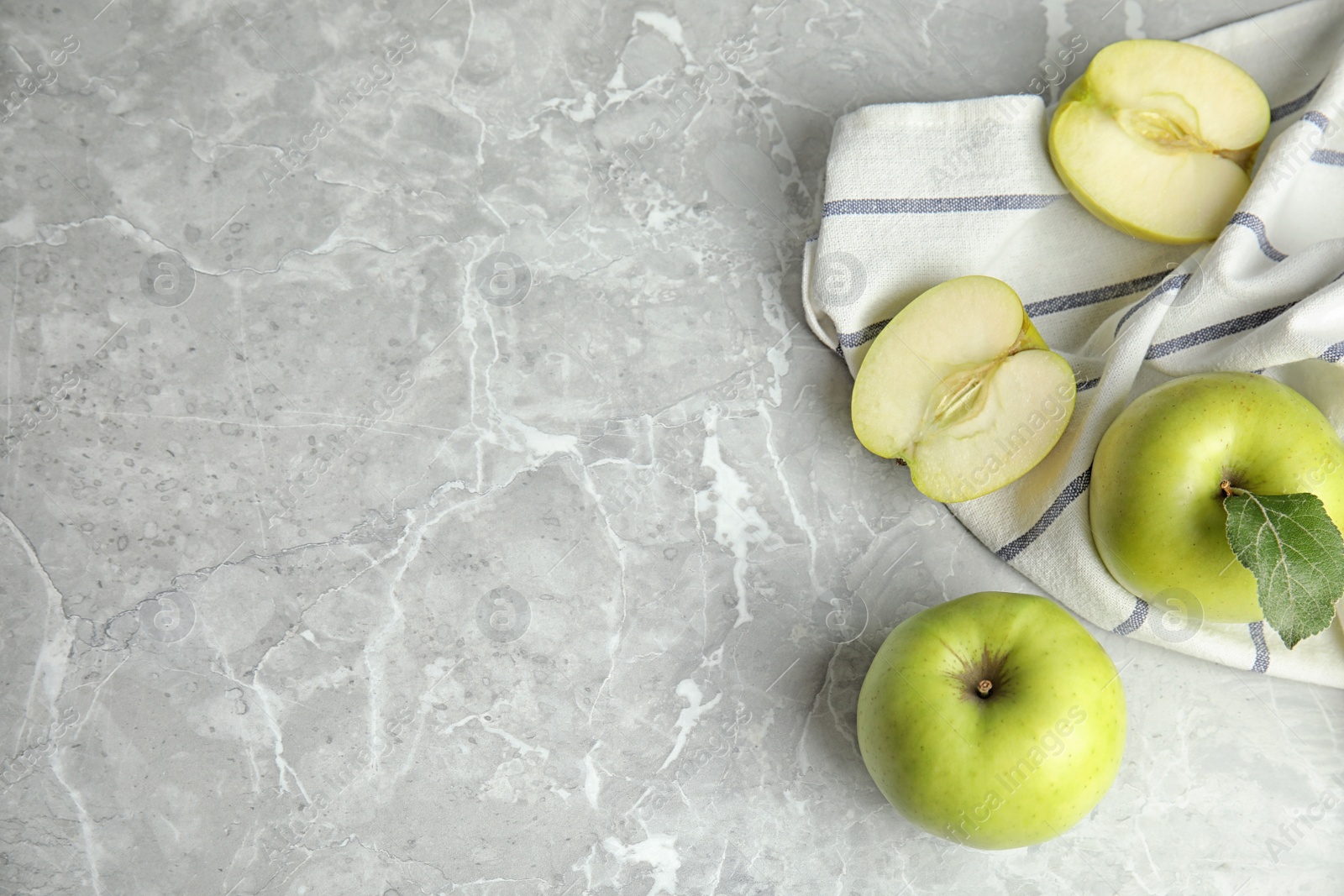 Photo of Flat lay composition of fresh ripe green apples on grey stone table, space for text