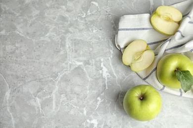 Photo of Flat lay composition of fresh ripe green apples on grey stone table, space for text