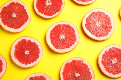 Photo of Fresh sliced ripe grapefruits on color background, flat lay