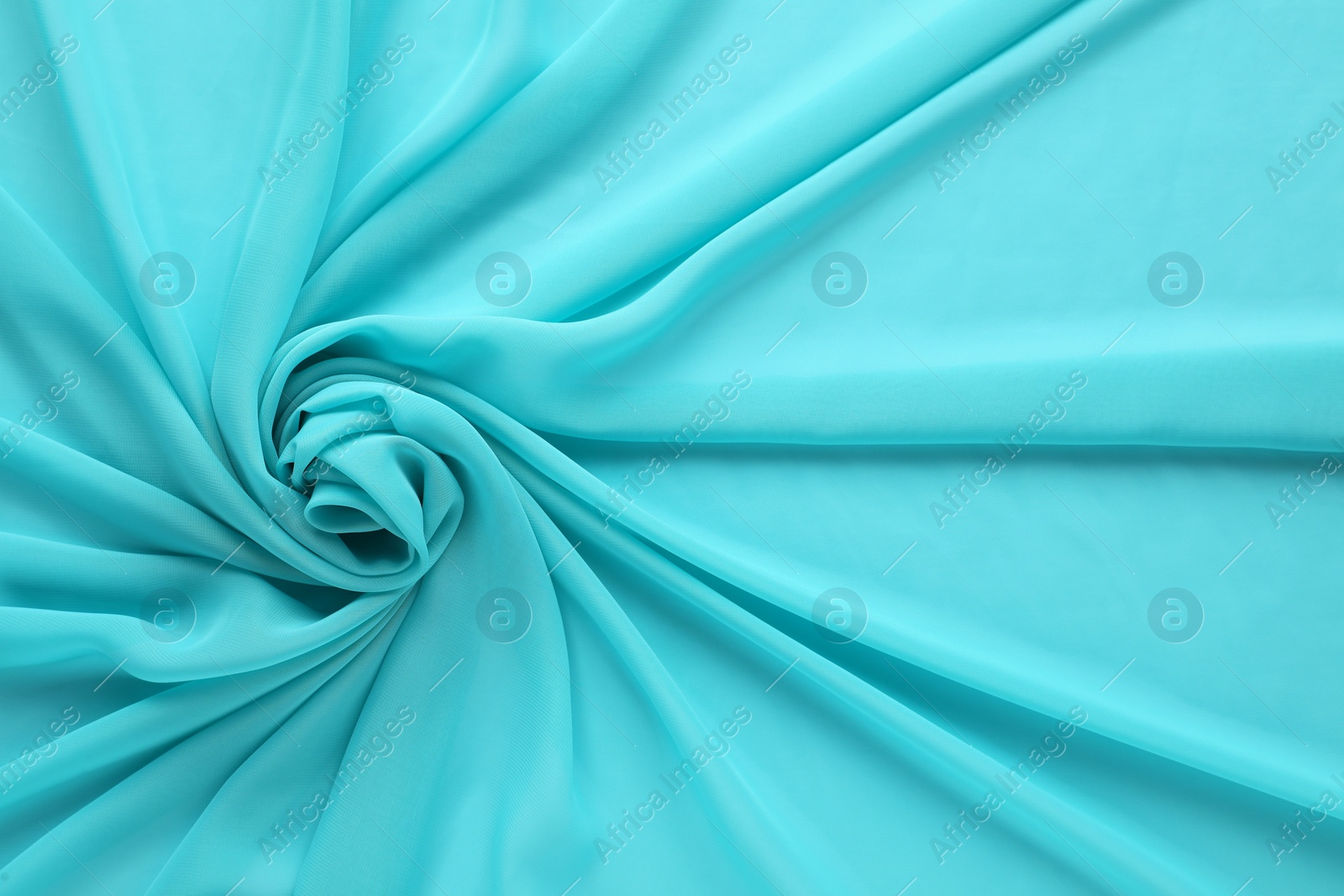 Photo of Beautiful turquoise tulle fabric as background, top view