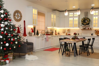 Cozy dining room interior with Christmas tree and beautiful festive decor