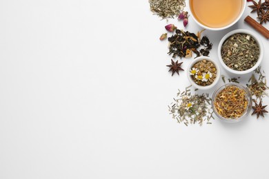 Composition with fresh brewed tea and dry leaves on white background, top view