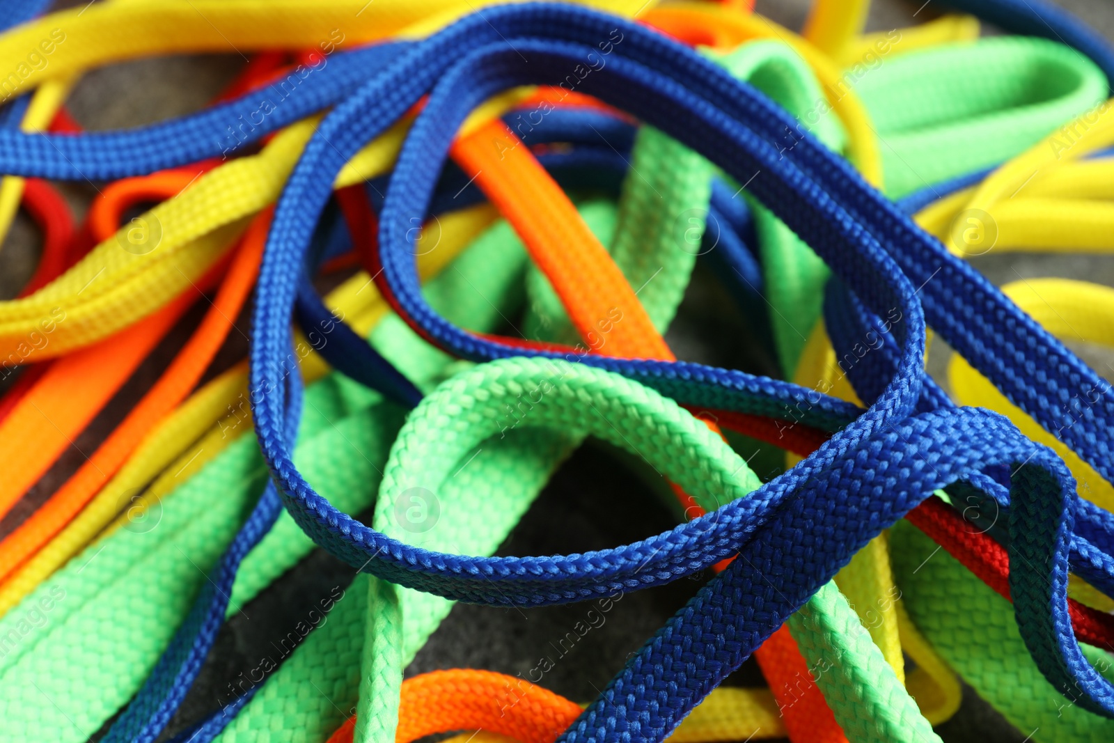 Photo of Colorful shoelaces on grey background, closeup. Stylish accessory