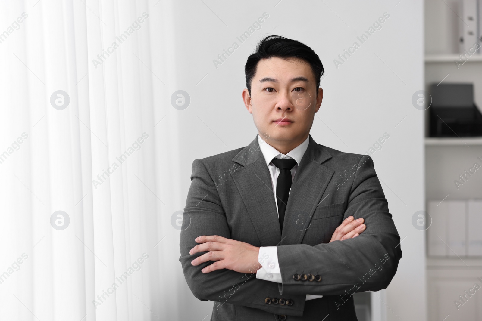 Photo of Portrait of confident notary with crossed arms indoors, space for text
