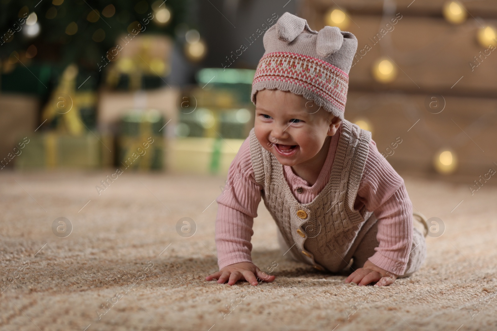 Photo of Cute little baby in room decorated for Christmas. Winter holiday