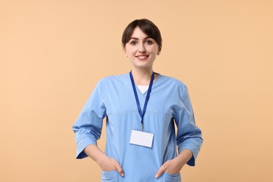Photo of Portrait of smiling medical assistant on beige background