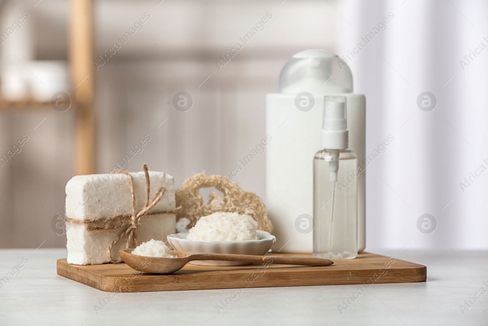 Photo of Board with Shea butter and cosmetic products on table indoors. Space for text