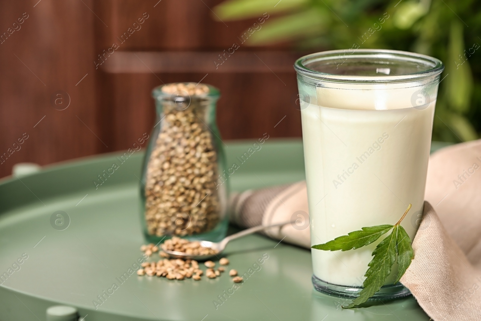 Photo of Composition with hemp milk on green table