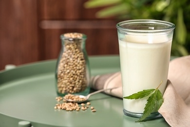 Composition with hemp milk on green table