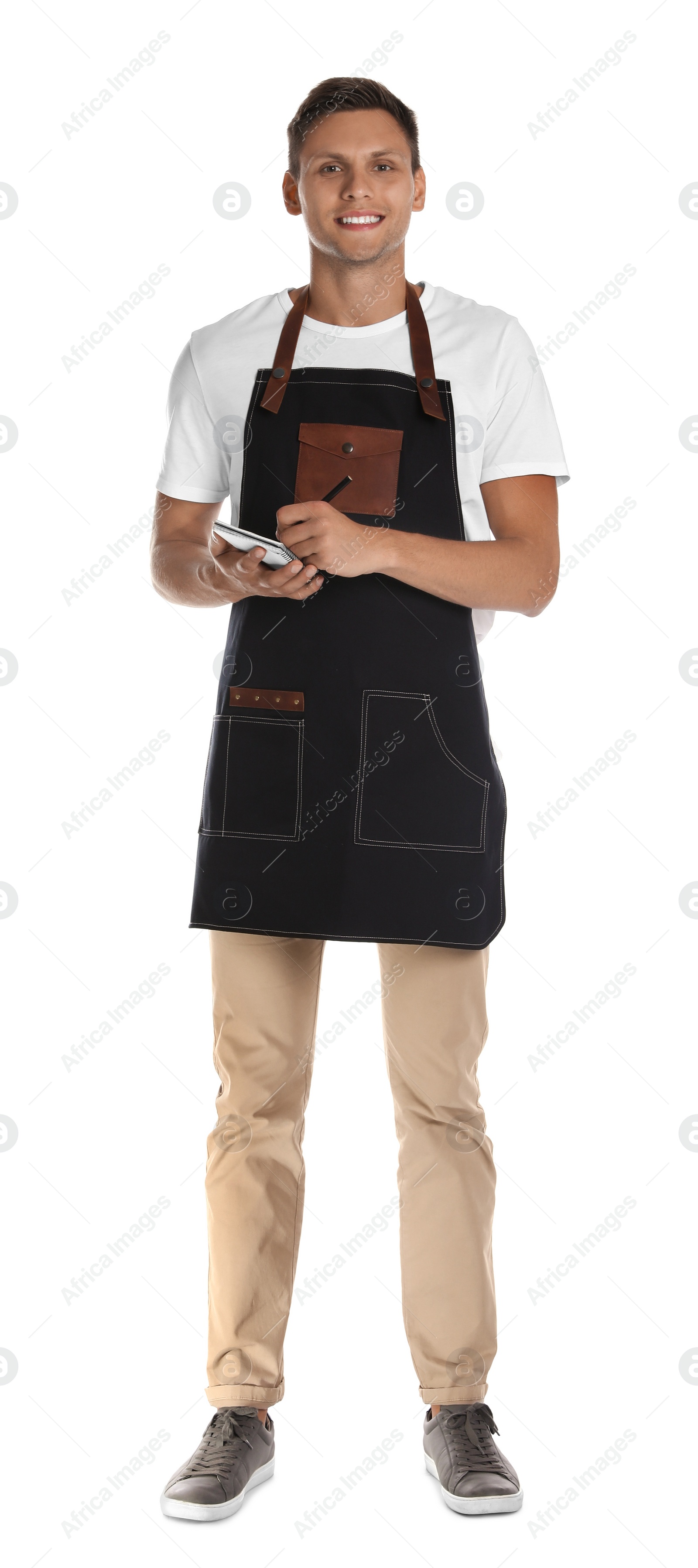 Photo of Full length portrait of happy young waiter with notebook on white background