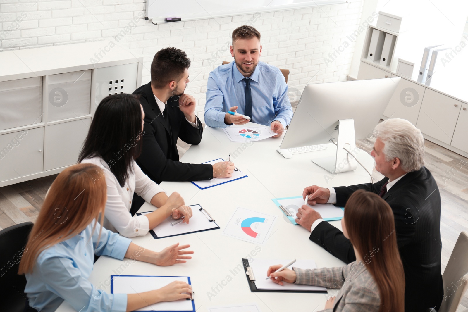 Photo of Professional business trainer working with people in office