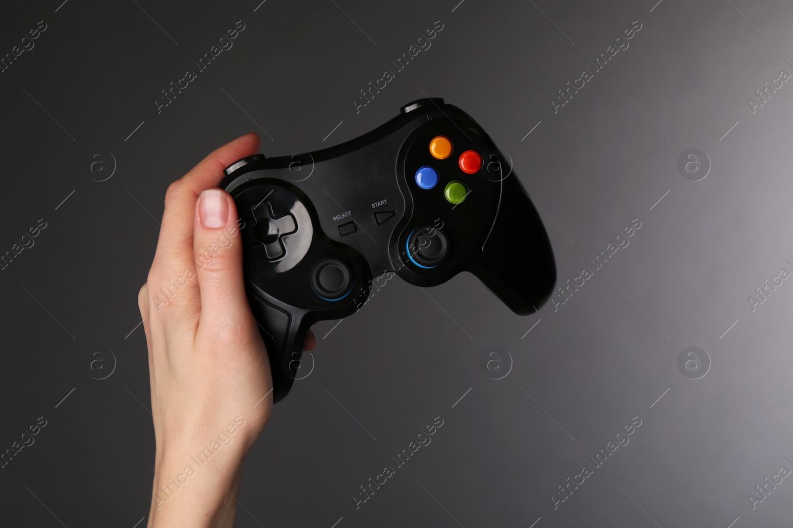 Photo of Woman with game controller on grey background, closeup