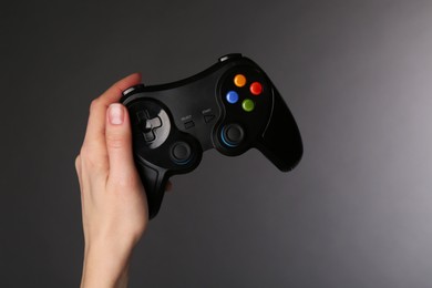 Photo of Woman with game controller on grey background, closeup