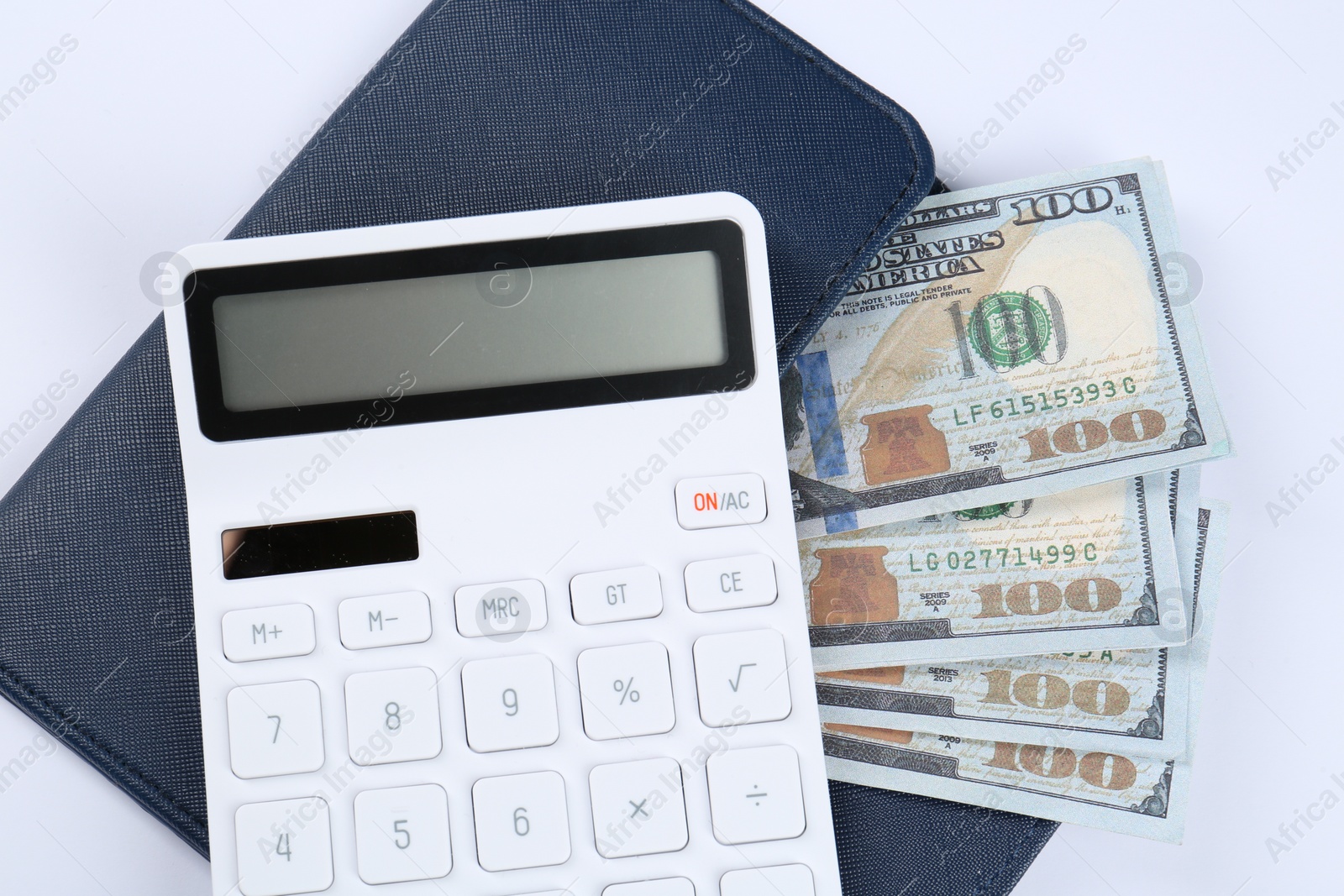 Photo of Calculator, dollar banknotes and wallet on white background, top view. Retirement concept