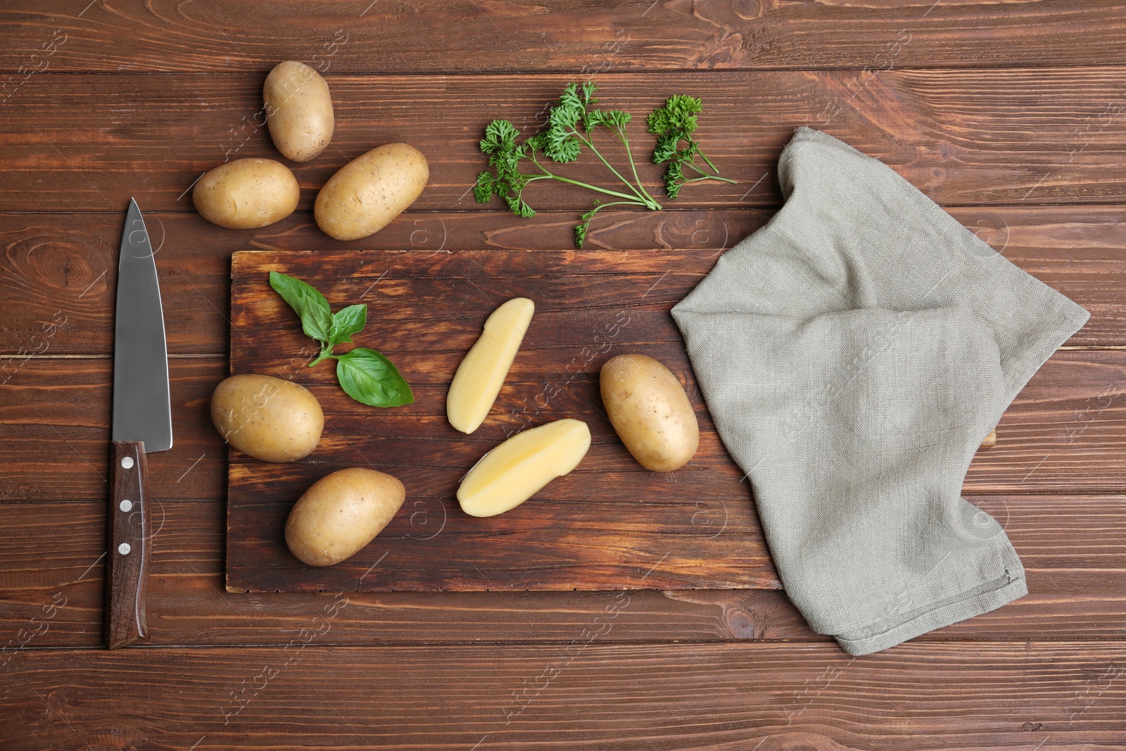 Photo of Flat lay composition with fresh organic potatoes on wooden background