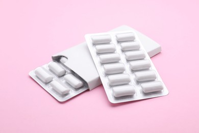 Photo of Blisters with chewing gums on pink background