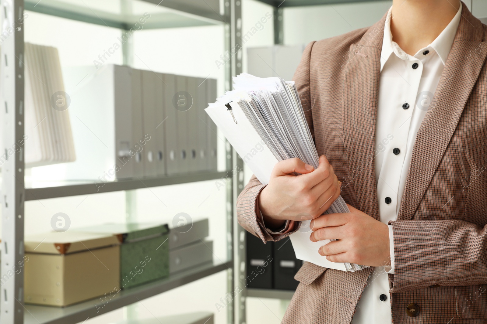 Photo of Female worker with documents in archive, closeup. Space for text