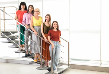 Photo of Group of ladies on stairs indoors. Women power