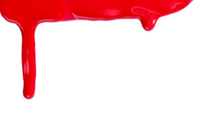 Photo of Red nail polish flowing on white background