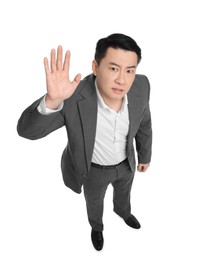Photo of Angry businessman in suit posing on white background, above view