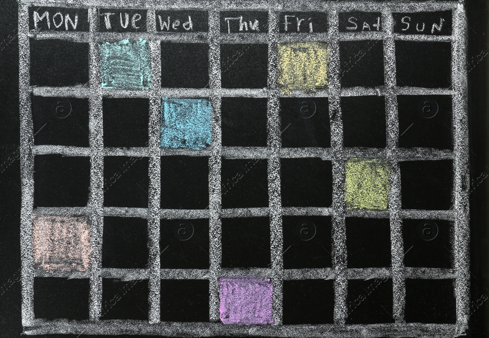 Photo of Weekly school timetable drawn with colorful chalk on blackboard