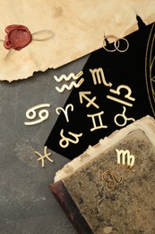 Photo of Flat lay composition with zodiac signs on grey textured table
