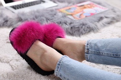 Photo of Woman in soft slippers at home, closeup