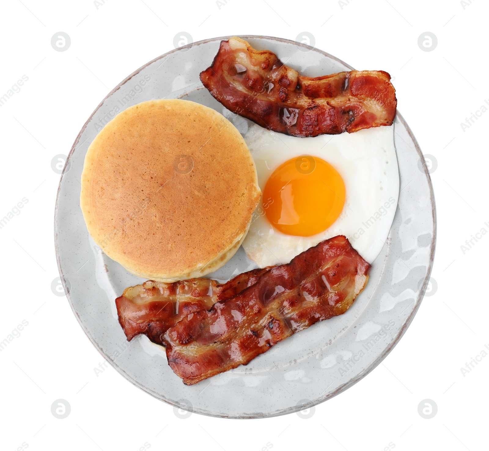 Photo of Plate with tasty pancakes, fried egg and bacon isolated on white, top view