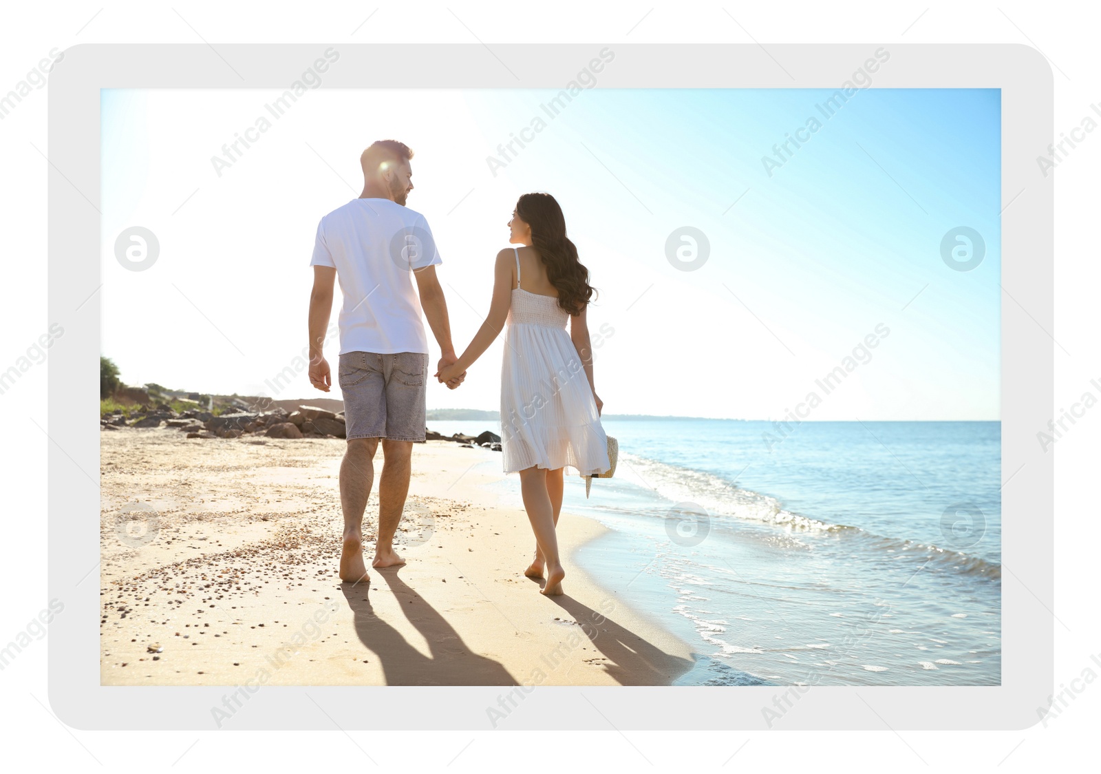 Image of Paper photo. Happy young couple walking on beach near sea 