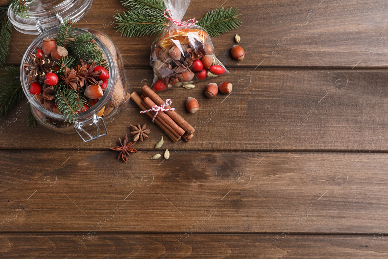 Photo of Aroma potpourri with different spices on wooden table, flat lay. Space for text