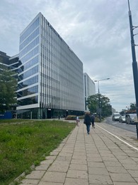 Photo of WARSAW, POLAND - JULY 13, 2022: City street with beautiful building, pavement and highway