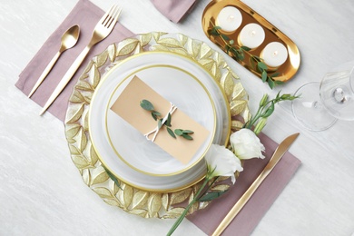 Photo of Elegant festive table setting on light background, flat lay