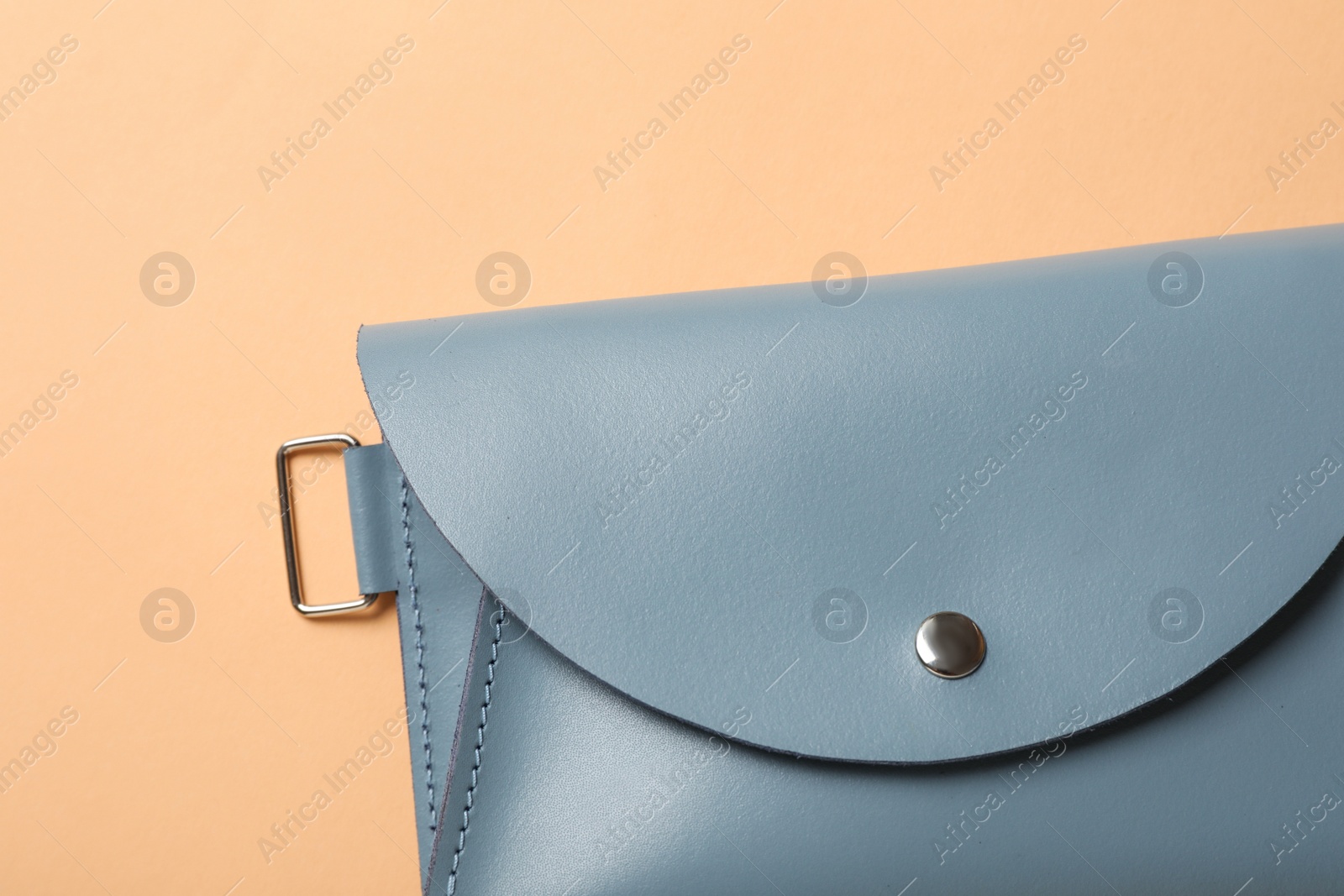 Photo of Stylish women's bag on pale orange background, top view