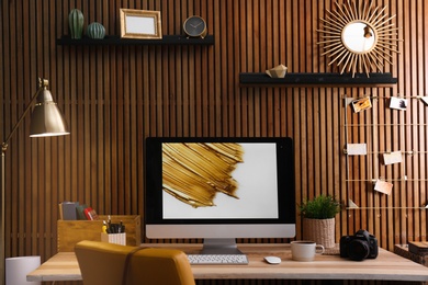 Photo of Modern computer on desk in room. Home workplace